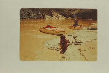 Washing dishes at lunch camp; Mile 151.6, right bank.  Reilly-Reynolds party; Susie Reilly in foreground