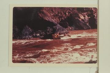 The Deck-Boat starting into Vulcan Rapid.  Jim-Bob Rowlands is at the wheel.  Dock Marston is piloting.  Jim Jordan and Shell Wimpfen sit aft