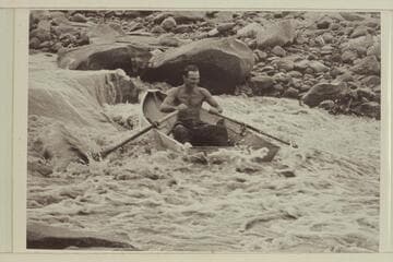 Norm Nevills at 13-Foot Rapid, San Juan River.  The boat is one of Ansel Hall's folding spruce skiffs.  The flow in the river is less than 400 cfs