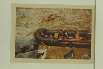 Pontoon No. 2 of the Don Hatch party, Vulcan Rapid.  The effort is being made to clear the rocks after lining the upper part of the rapid.  Boatmen are Galloway and Allan
