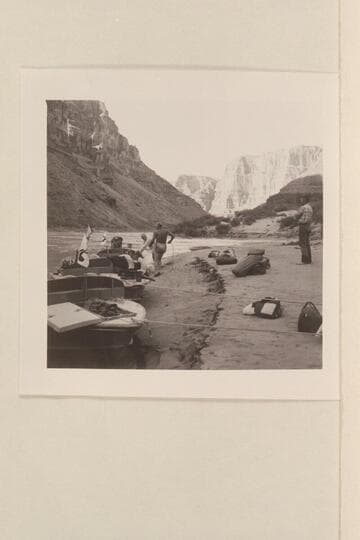 The three boats moored at camp near Mile 210.  Joe and Rod work at the lines while Hugh looks on