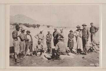 USGS 1923 survey party with the Smiths at Griggs [sic] Ferry.  Left to right:  LaRue; Moore; Koms; Dodge (sitting); Stabler; Blake; Burchard; Birdseye; Lint; and Smiths.  E. C. Kolb at extreme right end