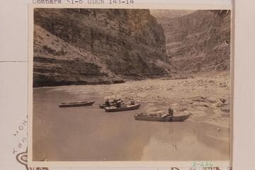 Crew and boats of the 1934 party at the mouth of Kanab Creek with Kanab Creek Rapid in background