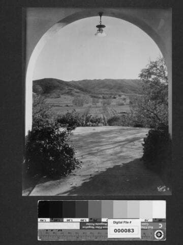 View of landscape through archway at Milflores, Spanish-style home of Harrison Gray Otis
