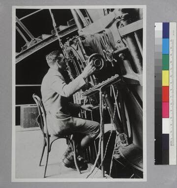 Edwin Powell Hubble seated at the 100 inch Hooker Telescope, Mount Wilson Observatory