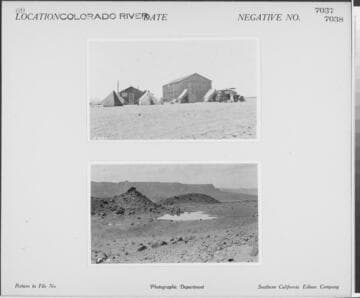 Colorado River - shot of tent camp and vehicle near wood barn in desert
