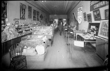 George W. Ingalls standing inside the Nevada Chamber of Commerce, located near the Southern Pacific Depot, Reno