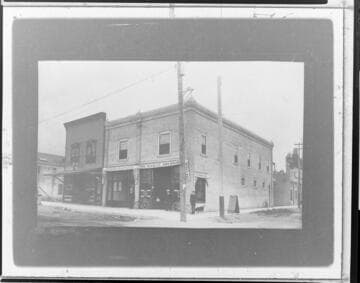 A man and a dog standing outside the Edison Electric Company local office in Monrovia around 1905