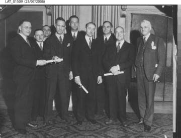 Harry Chandler poses with others holding certificates
