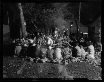 Scouts sitting in a camp circle at Santa Monica Girl Scout camp