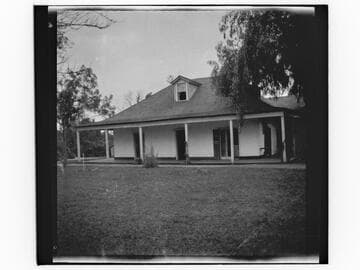 Unidentified adobe house with lawn