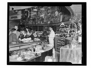 Interior of an unidentified bar, with bartender and customers