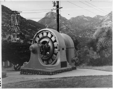 One of the original Kaweah generators still stands in front of the modernized Kaweah #1 Hydro Plant