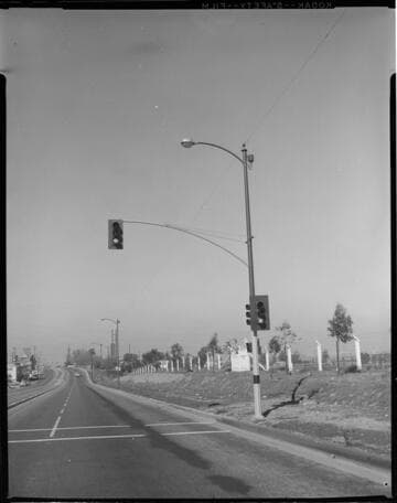 Day and night shots of streetlighting in a commercial area