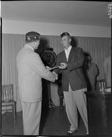 Two American Legion members passing the gavel to the new president