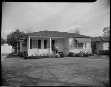 Man and woman standing on their front porch