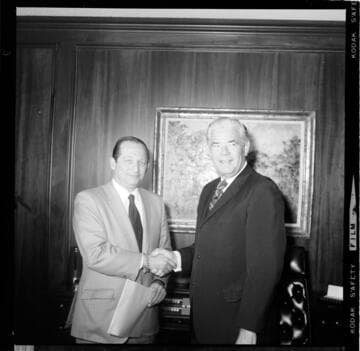 Executive signing document his office