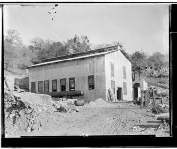 Kaweah #2 Power House under construction.  The end of the pipe is next to the side of the building and construction supplies surround the area