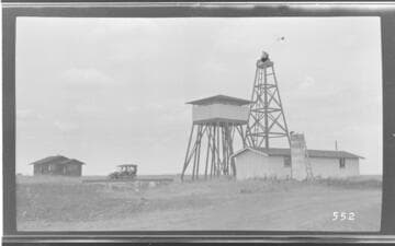 A group of people in an automobile at a pumping plant in Tulare County