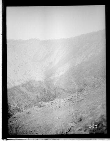 Two men standing on rocks in a pond