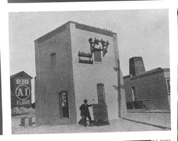 Man standing by electric substation