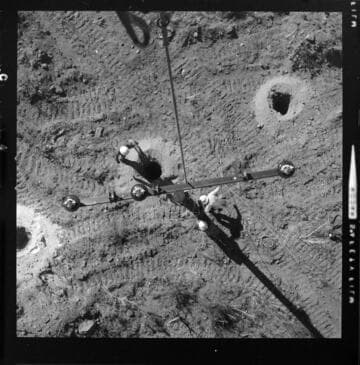 "Skycrane" helicopter transporting pre-assembled, H-frame pole towers, and single poles into remote tower sites for installation