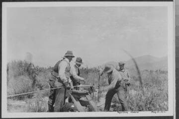 Line crew of 4 CEP workers splicing aluminum steel cable in the desert
