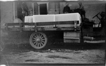 Two men in large flat-bed truck