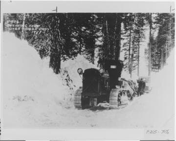 Prior to the development of the purpose built "Sno-Cat" for winter use, specially modified Caterpillar tractors were used to carry supplies over snowed-in roads