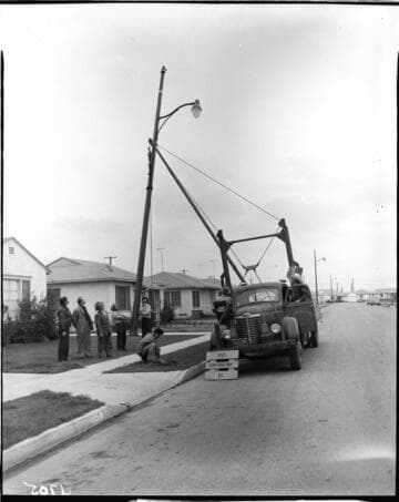 State Construction Company crew installing new street light in residential track