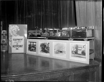 Commercial Hotpoint fryers and enlarged photos of their restaurant use on the stage the G