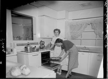 Two people in model kitchen for cooking demonstration