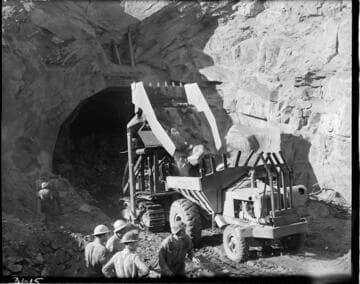 Tunnel mucker dumping load at mouth of Big Creek 4's powertunnel