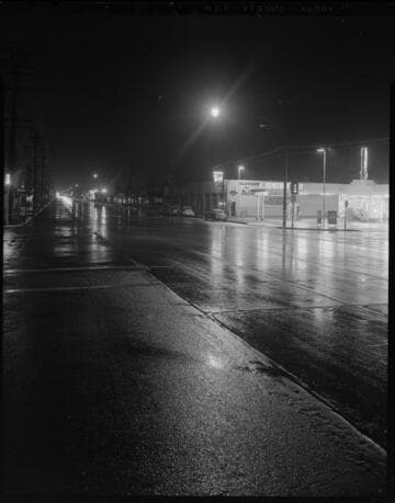 Street lighting at night on wet Alhambra Street