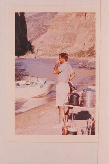 George Morrison works at getting awake.  Camp at foot of Vulcan Rapid