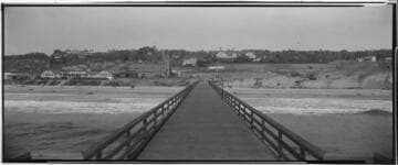 Beach, hotel, and buildings from a pier, Del Mar. 1926
