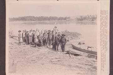 USGS before leaving Green River, Utah, 1921.  Emery Kolb standing with oar; Ellsworth Kolb kneeling.To his right, Henry Rauch, Emery's assistant.Leigh Lint, rodman, second from right.E. C. LaRue with hands on hips. Clogston to his left