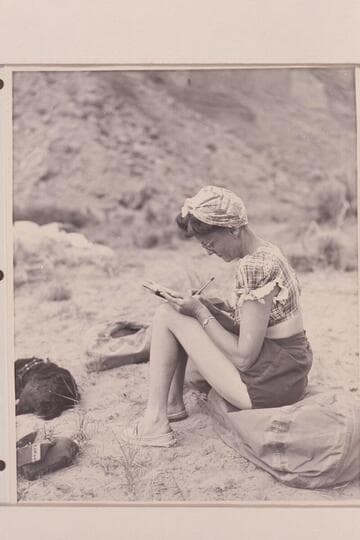 Becky Walker on Dolores River [on photo reverse:  Mrs. Walker bringing diary up to date and dog "Detty."