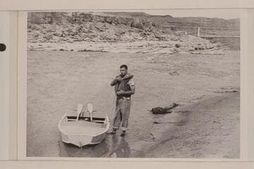 Don Wimpress and the 8 foot pram with which he navigated the San Juan and lower Glen Canyon in 1952, May-June; Mexican Hat