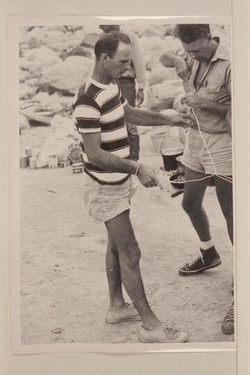 Norm Nevills working on puzzles at Diamond Creek in Grand Canyon during his 6th traverse.  John Doerr at right