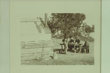 Bass Camp. W. W. Bass at end of table with dog "Shep;" at his right is George Wharton James