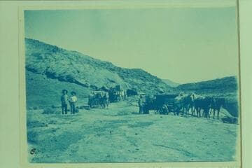 Supplies being hauled in for building the Hoskanini Dredge. R. B. Stanton, Jr. and A. B. Starr (friend) in foreground