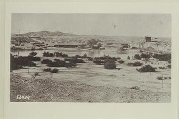Yuma, Arizona, from Fort Yuma. The steamer appears to be the "Gila" and the long buildings left of center are the warehouses of the steamship company